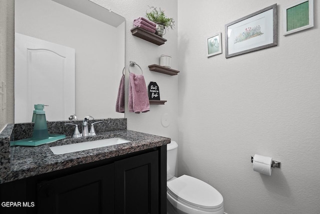 bathroom featuring toilet and vanity