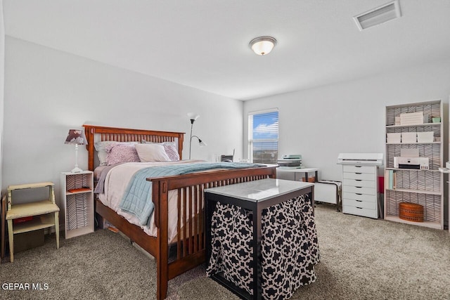 carpeted bedroom featuring visible vents