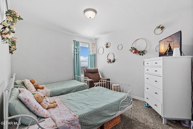 carpeted bedroom featuring baseboards