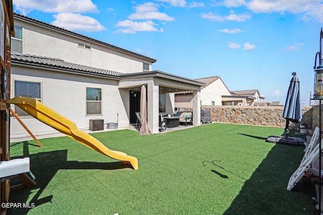 view of yard with a patio area, a playground, and fence