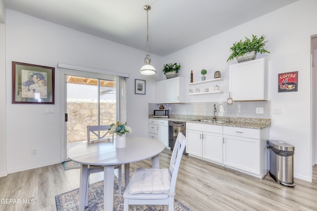 dining room featuring light wood-style floors and baseboards