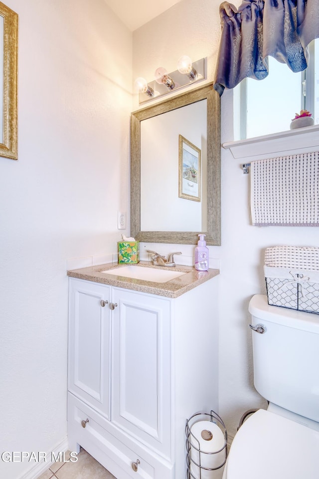 bathroom with toilet and vanity