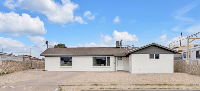 rear view of house featuring fence