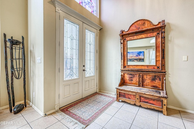 entrance foyer featuring light tile patterned flooring and baseboards