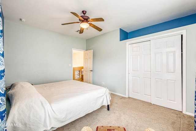 carpeted bedroom with a closet, baseboards, and a ceiling fan