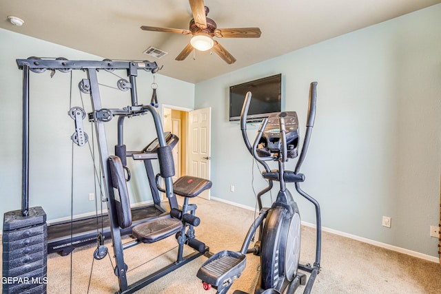 exercise area featuring visible vents, baseboards, light colored carpet, and a ceiling fan