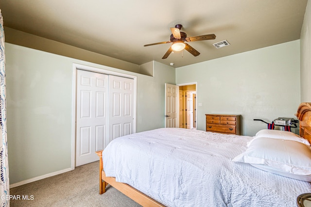 bedroom with carpet, visible vents, baseboards, ceiling fan, and a closet