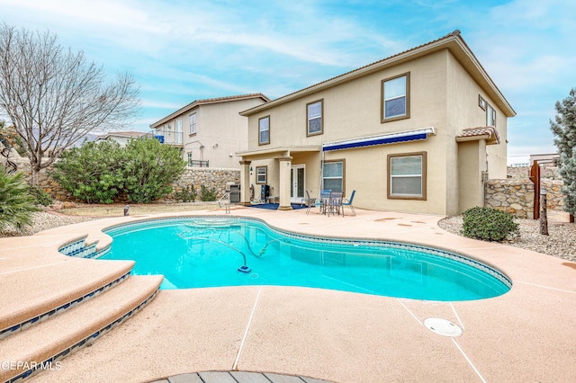 view of pool with a fenced in pool, a patio area, and fence