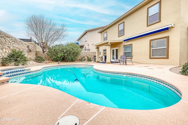 view of pool with a fenced in pool, french doors, a patio, and fence