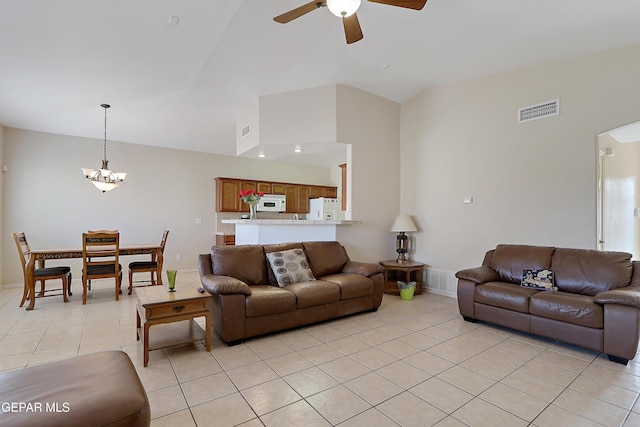 living room featuring high vaulted ceiling, ceiling fan with notable chandelier, visible vents, and light tile patterned floors