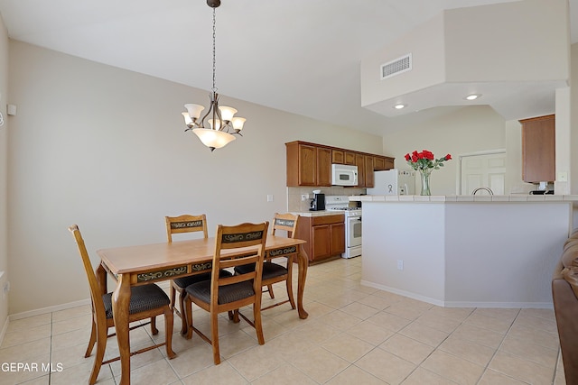 dining space with light tile patterned floors, baseboards, visible vents, vaulted ceiling, and a chandelier