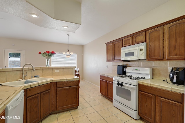 kitchen featuring white appliances, tasteful backsplash, tile countertops, a sink, and light tile patterned flooring