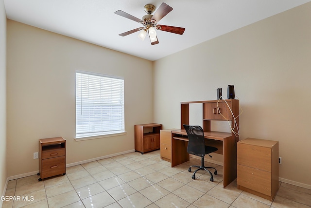 office featuring ceiling fan, light tile patterned floors, and baseboards