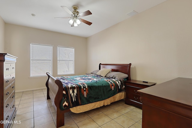 bedroom featuring light tile patterned floors, a ceiling fan, and baseboards