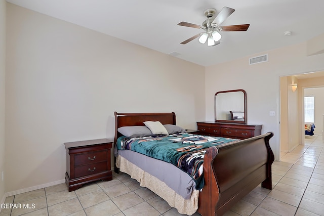 bedroom featuring ceiling fan, light tile patterned flooring, visible vents, and baseboards