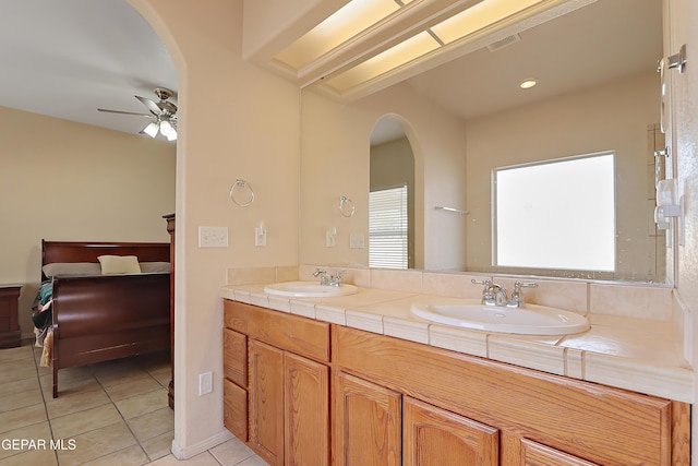 full bathroom with a ceiling fan, ensuite bath, visible vents, and a sink