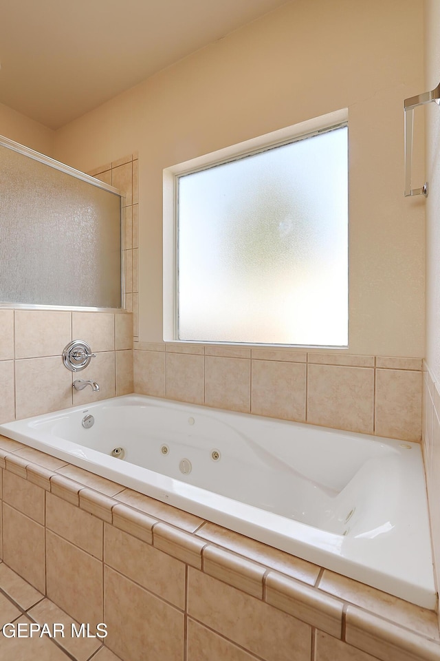 bathroom with a whirlpool tub and an enclosed shower