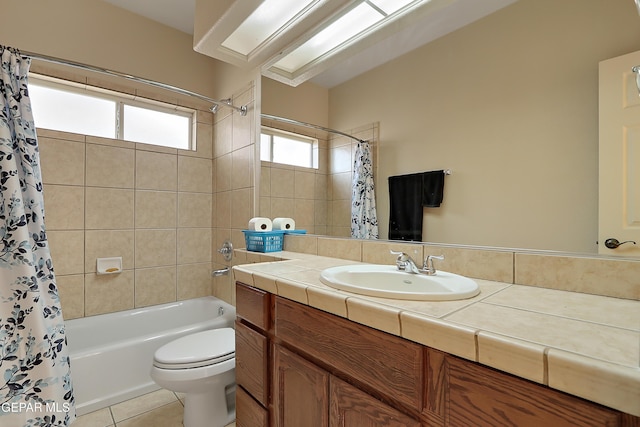 full bathroom with shower / tub combo with curtain, vanity, toilet, and tile patterned floors