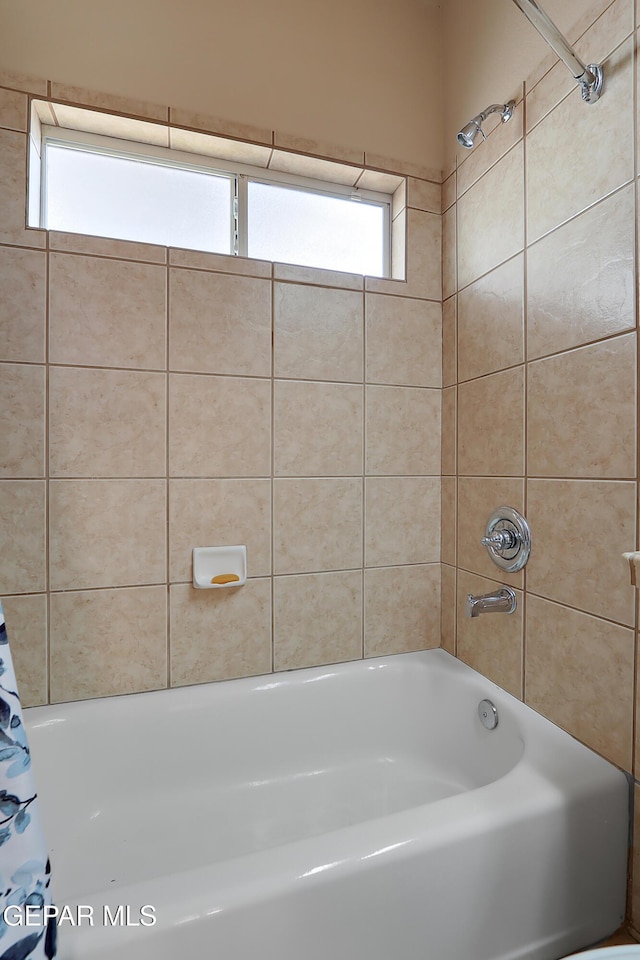 full bathroom with plenty of natural light and shower / bath combo with shower curtain