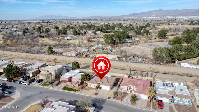 drone / aerial view featuring a residential view and a mountain view