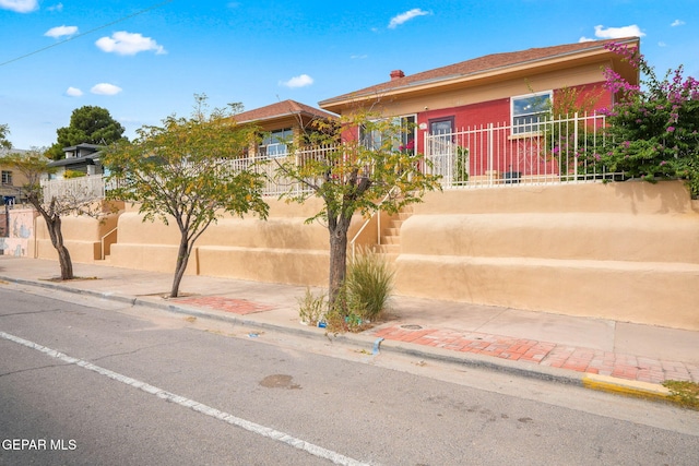 view of front of house featuring fence