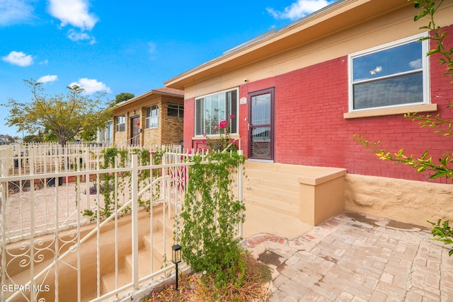 exterior space with brick siding and fence