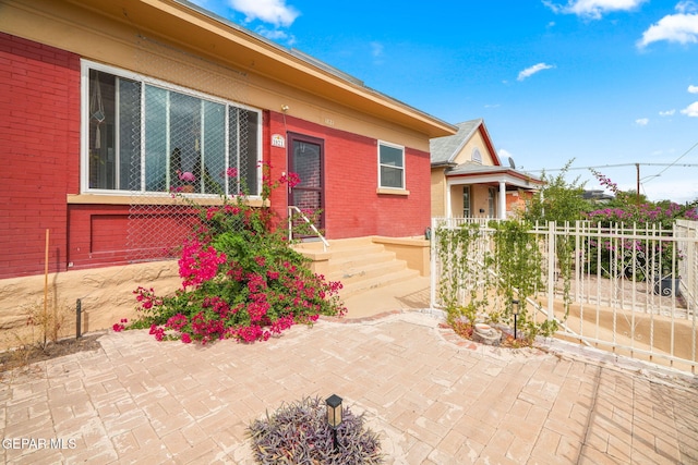 view of front of home with fence and brick siding