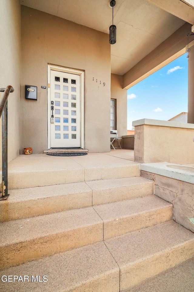 property entrance featuring stucco siding