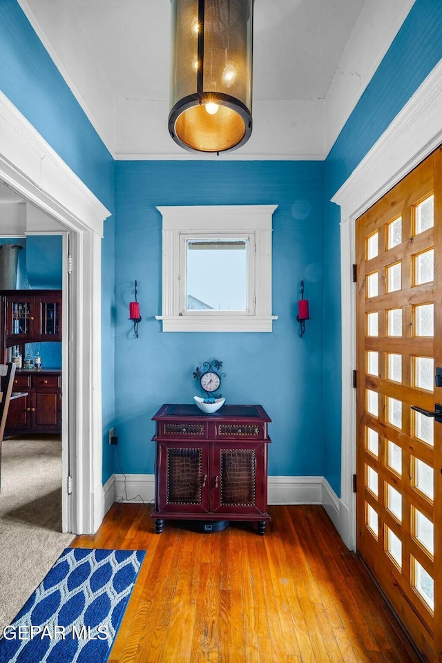 entryway featuring hardwood / wood-style floors and baseboards