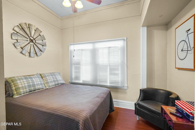 bedroom featuring wood finished floors and baseboards