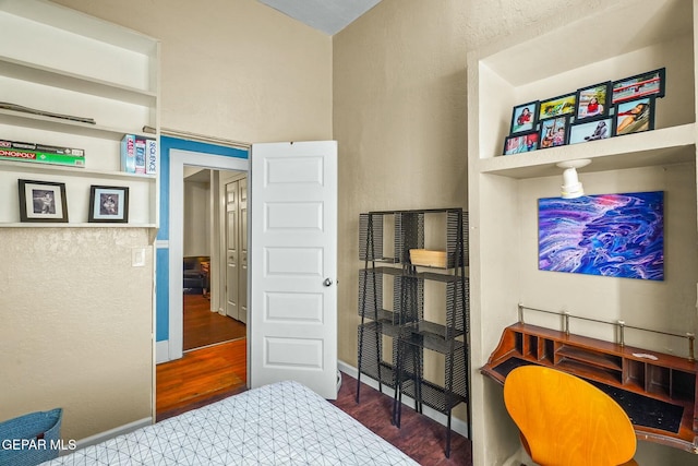 bedroom with baseboards and wood finished floors