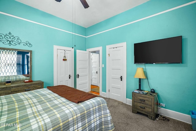 carpeted bedroom featuring baseboards and a ceiling fan