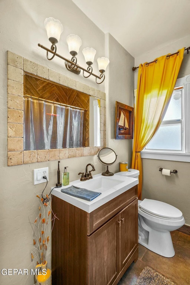 bathroom featuring vanity and toilet