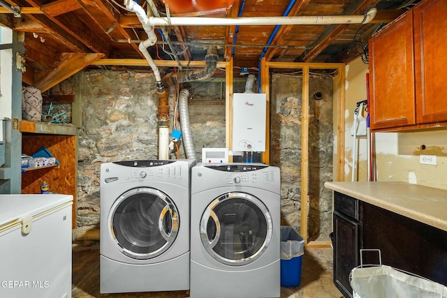 laundry room with washer and clothes dryer and cabinet space