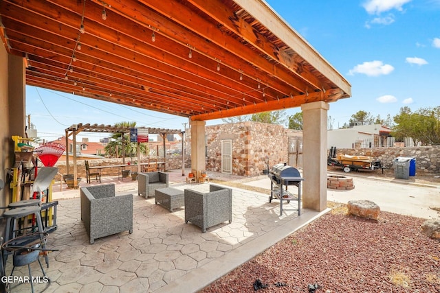 view of patio featuring area for grilling and an outdoor living space with a fire pit