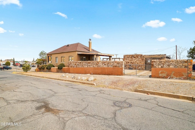 exterior space with a fenced front yard and stucco siding