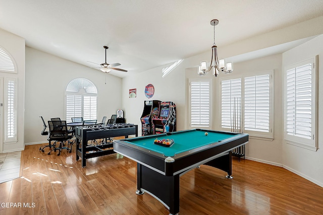 game room with vaulted ceiling, ceiling fan with notable chandelier, wood finished floors, and baseboards