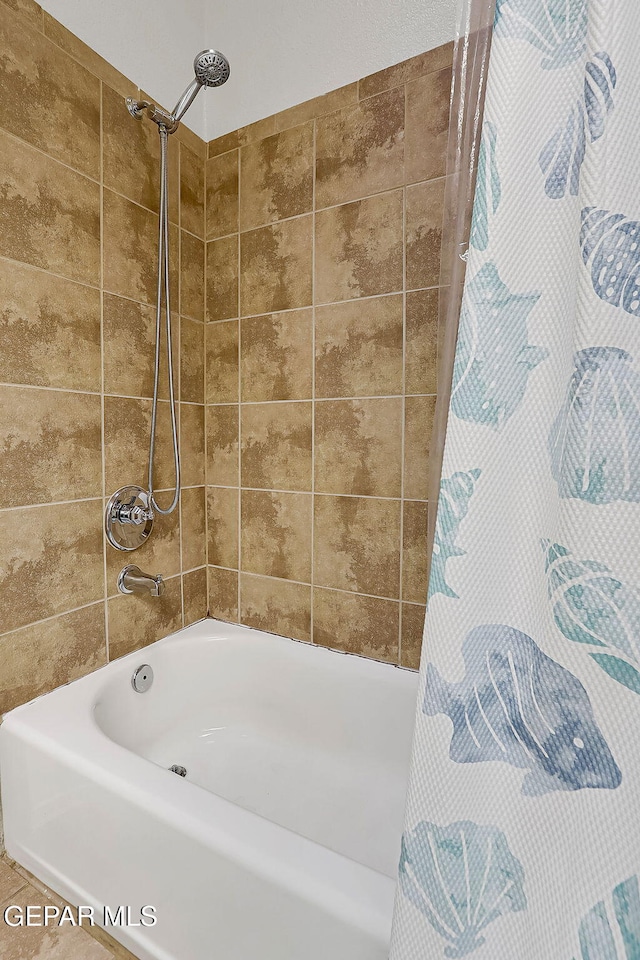 bathroom featuring shower / bathtub combination with curtain