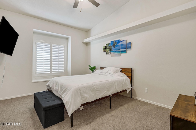 carpeted bedroom with baseboards, vaulted ceiling, and a ceiling fan