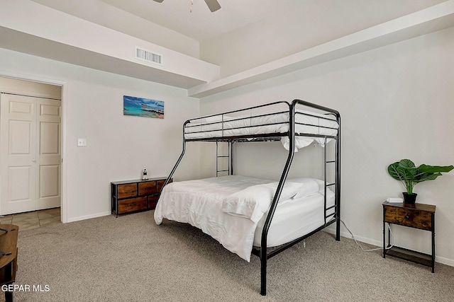 bedroom featuring light colored carpet, ceiling fan, visible vents, and baseboards