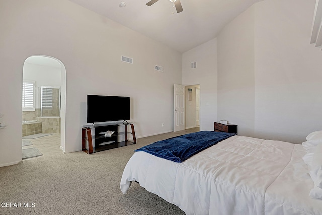 bedroom with arched walkways, carpet flooring, and visible vents