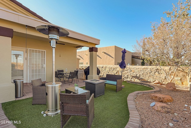 view of patio / terrace with outdoor dining area, fence, and a fire pit