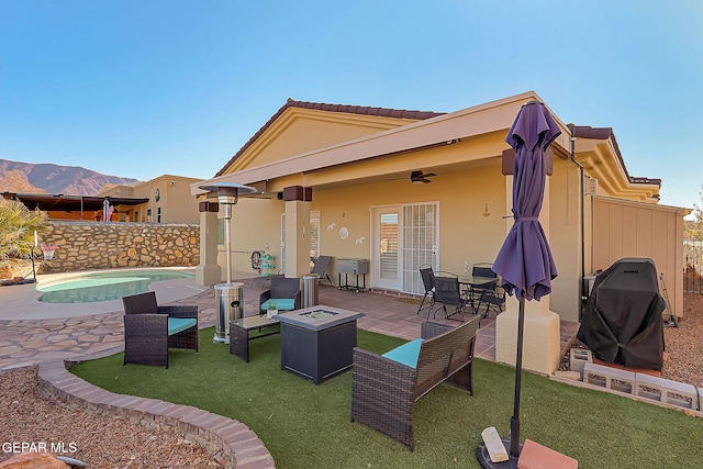 view of patio / terrace featuring a fenced in pool, a ceiling fan, an outdoor fire pit, a grill, and fence