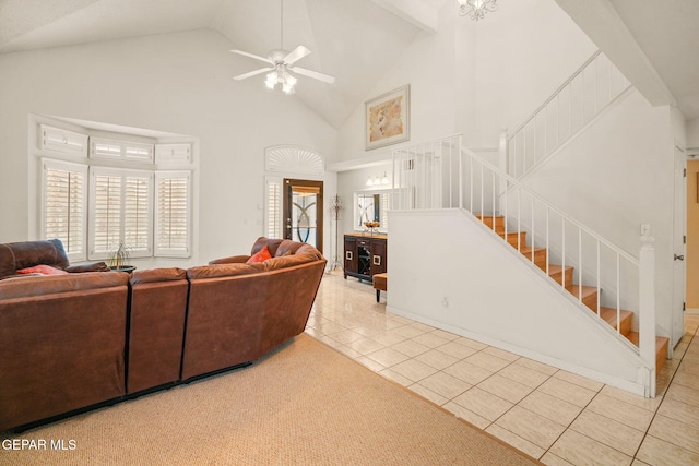 tiled living area featuring stairway, high vaulted ceiling, and a ceiling fan