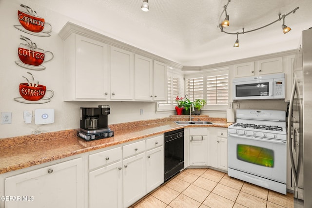 kitchen with white appliances, light tile patterned flooring, a sink, light countertops, and a textured ceiling