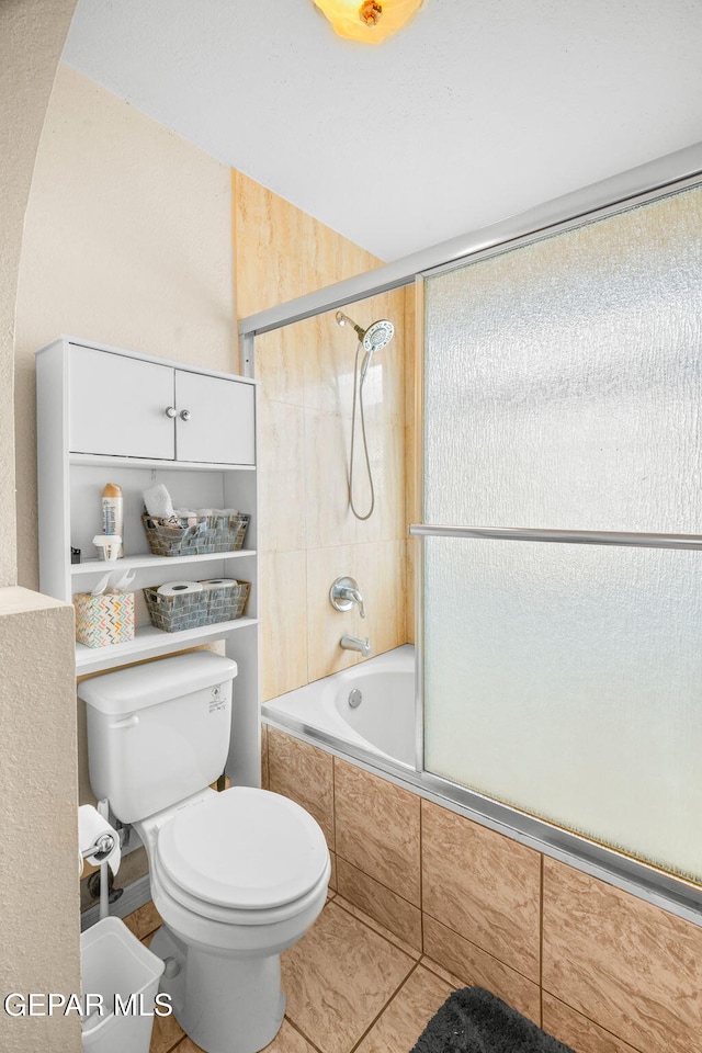 bathroom featuring toilet and tiled shower / bath combo