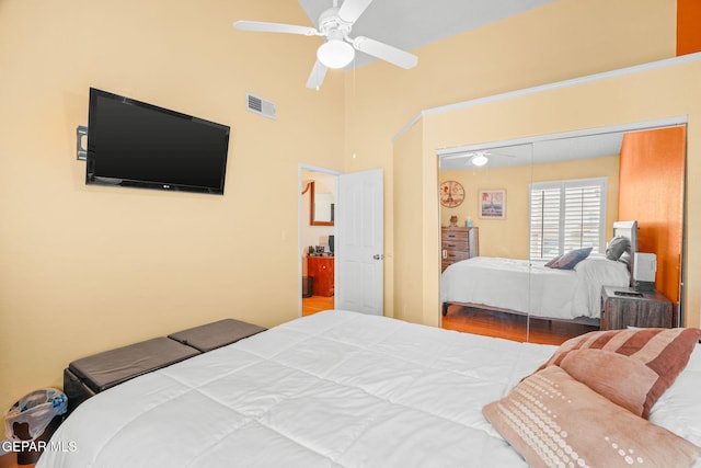 bedroom with visible vents, a closet, wood finished floors, and a ceiling fan