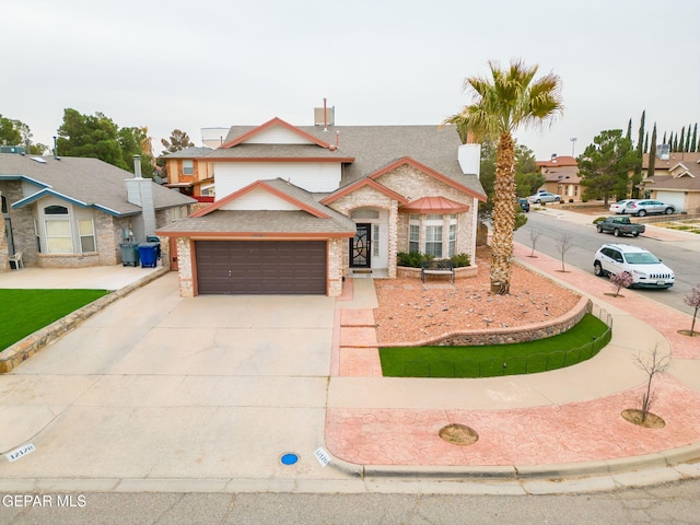 traditional home featuring concrete driveway and a garage