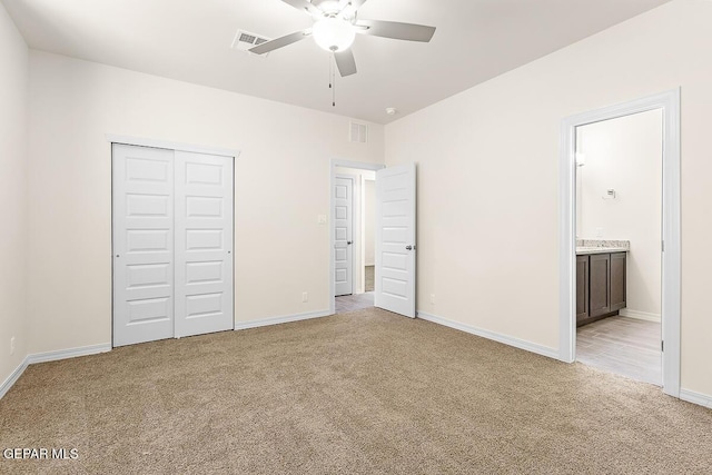 unfurnished bedroom with baseboards, a closet, visible vents, and light colored carpet