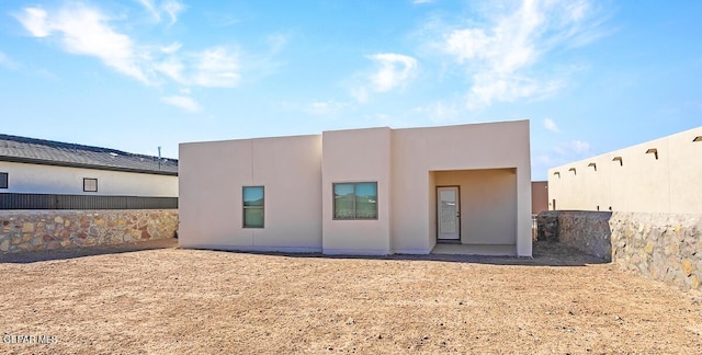 back of house with stucco siding